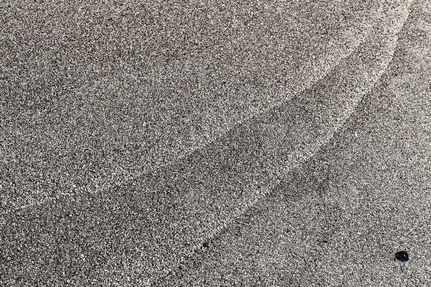 Sand texture pattern and stone. Summer beach background. photo