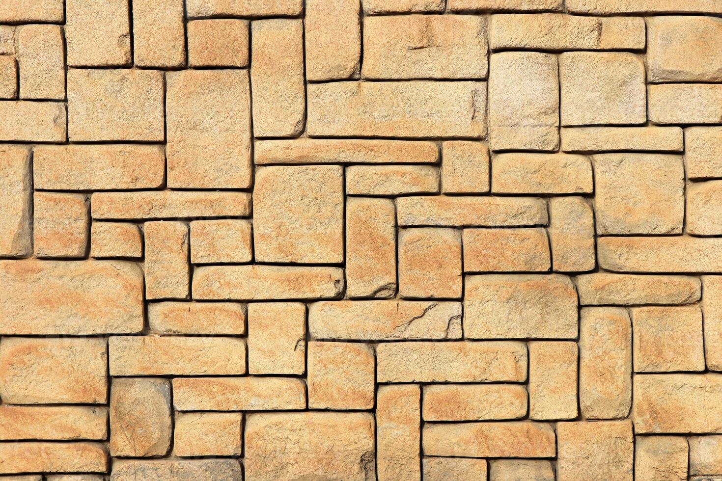 Masonry stone cladding wall texture. Geometric shapes surface background. photo