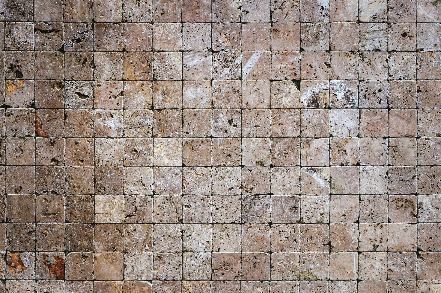 Square stones surface background. Travertine masonry tiles cladding wall texture. photo