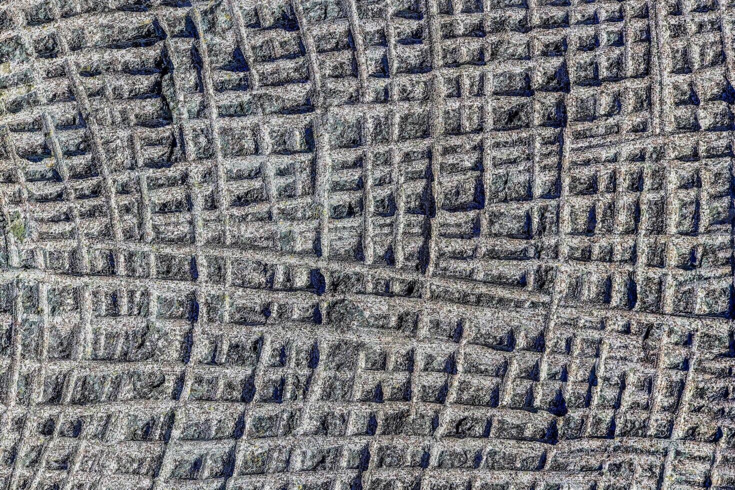 Sawn in a squares blue granite wall texture. Sawn in a squares blue granite wall texture. photo