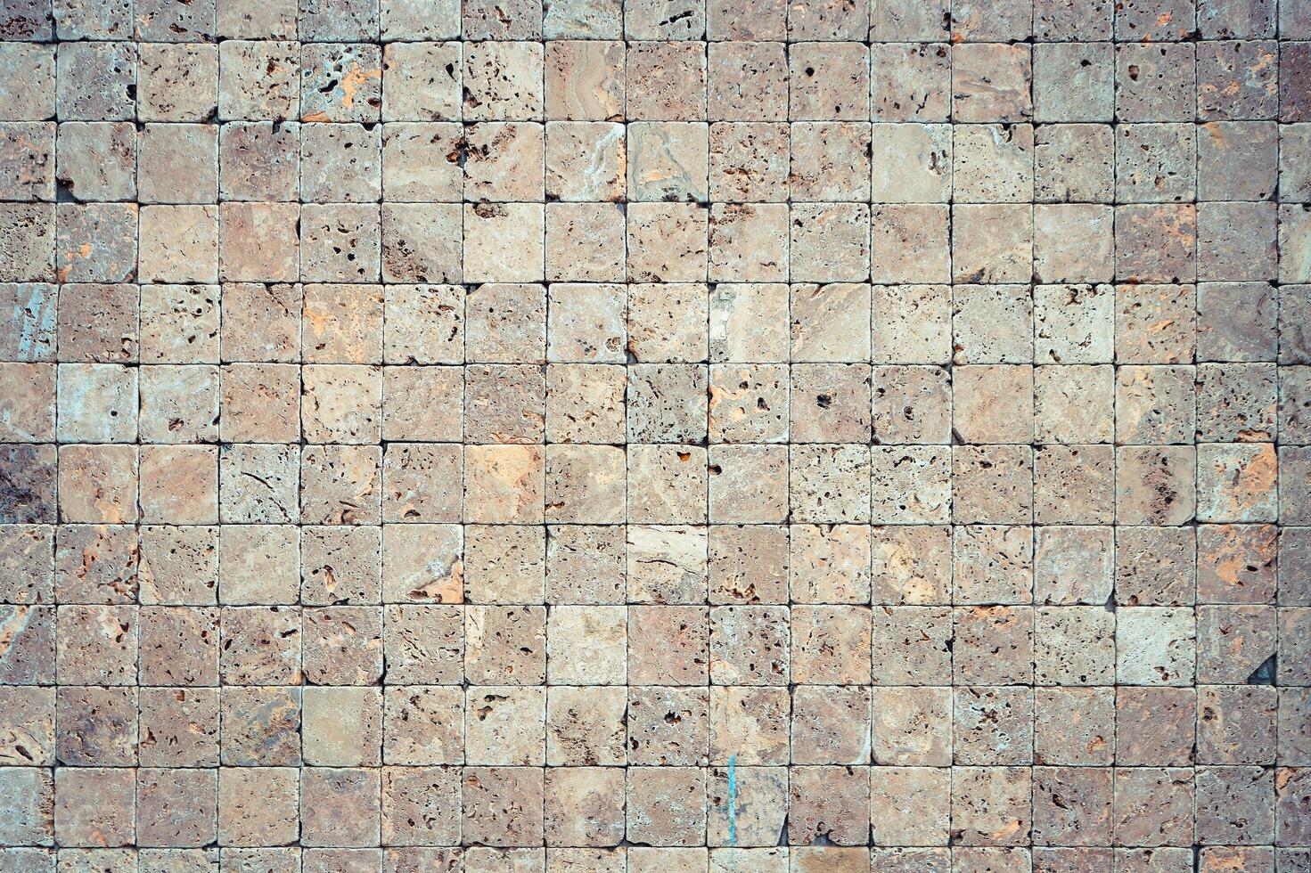 Square stones surface background. Travertine masonry tiles cladding wall texture. photo