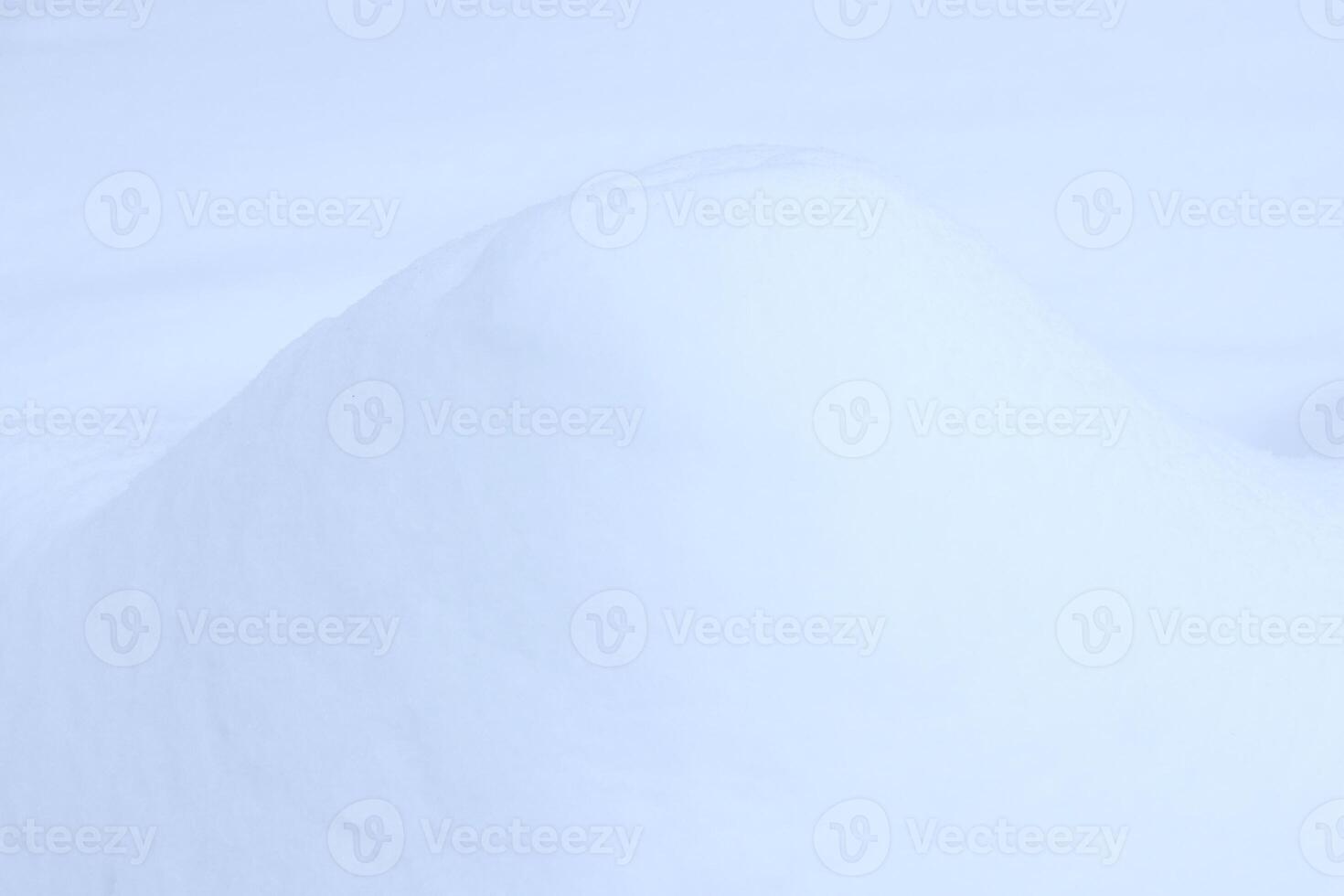 Snowy mound texture. Winter snowdrift landscape background. Soft snow hills surface. photo