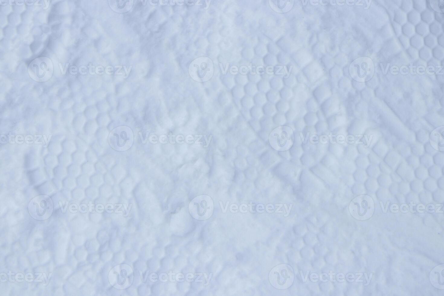 Snow boots track surface. Ski boot texture. Shoe sole traces background. photo