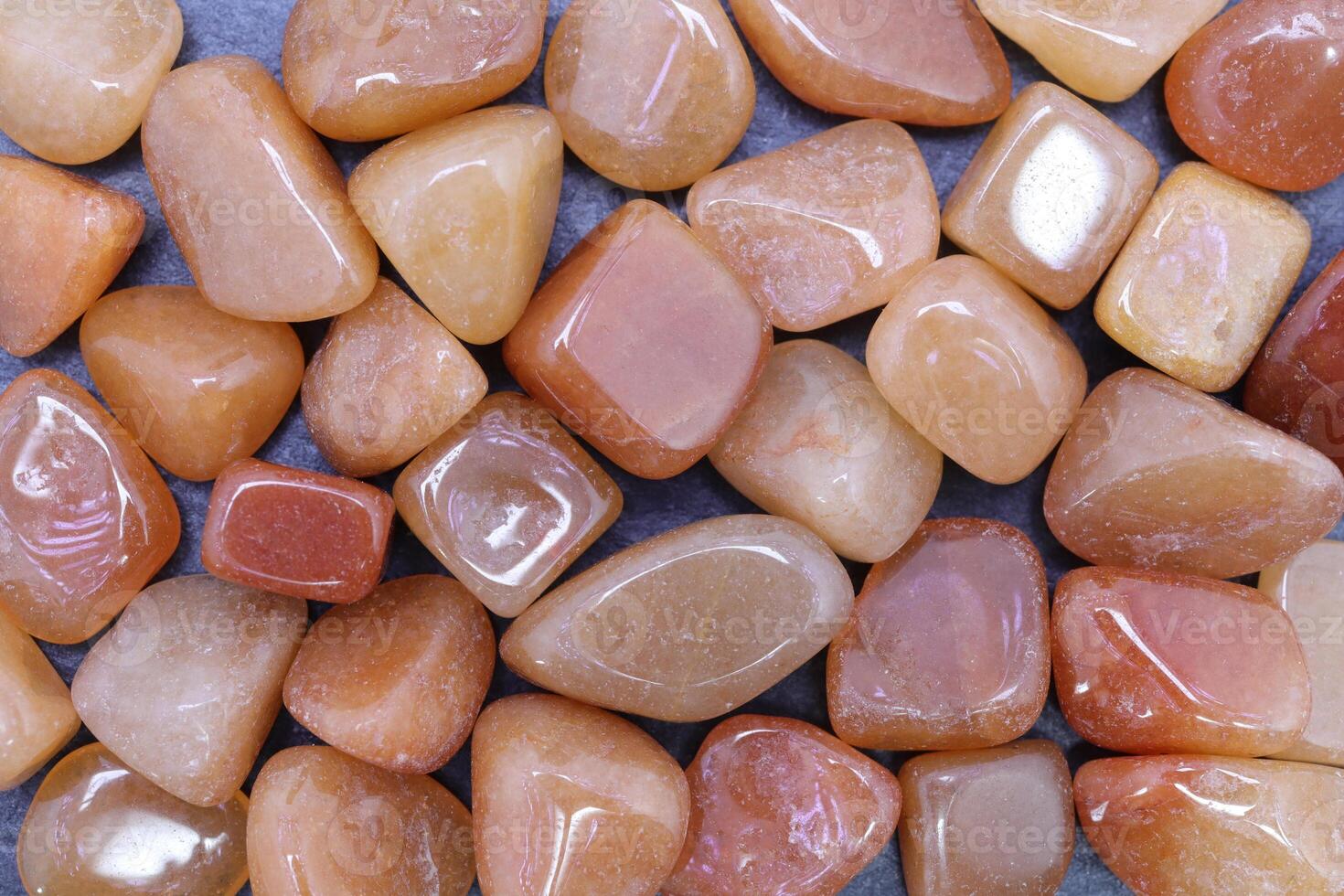 Red Aventurine heap jewel texture background. Pile mineral pebbles nature backdrop. photo