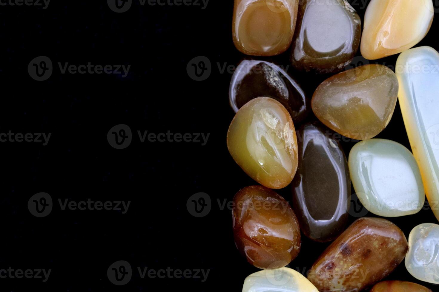 Yellow Agate heap jewel texture on half black stone background. Place for text. photo