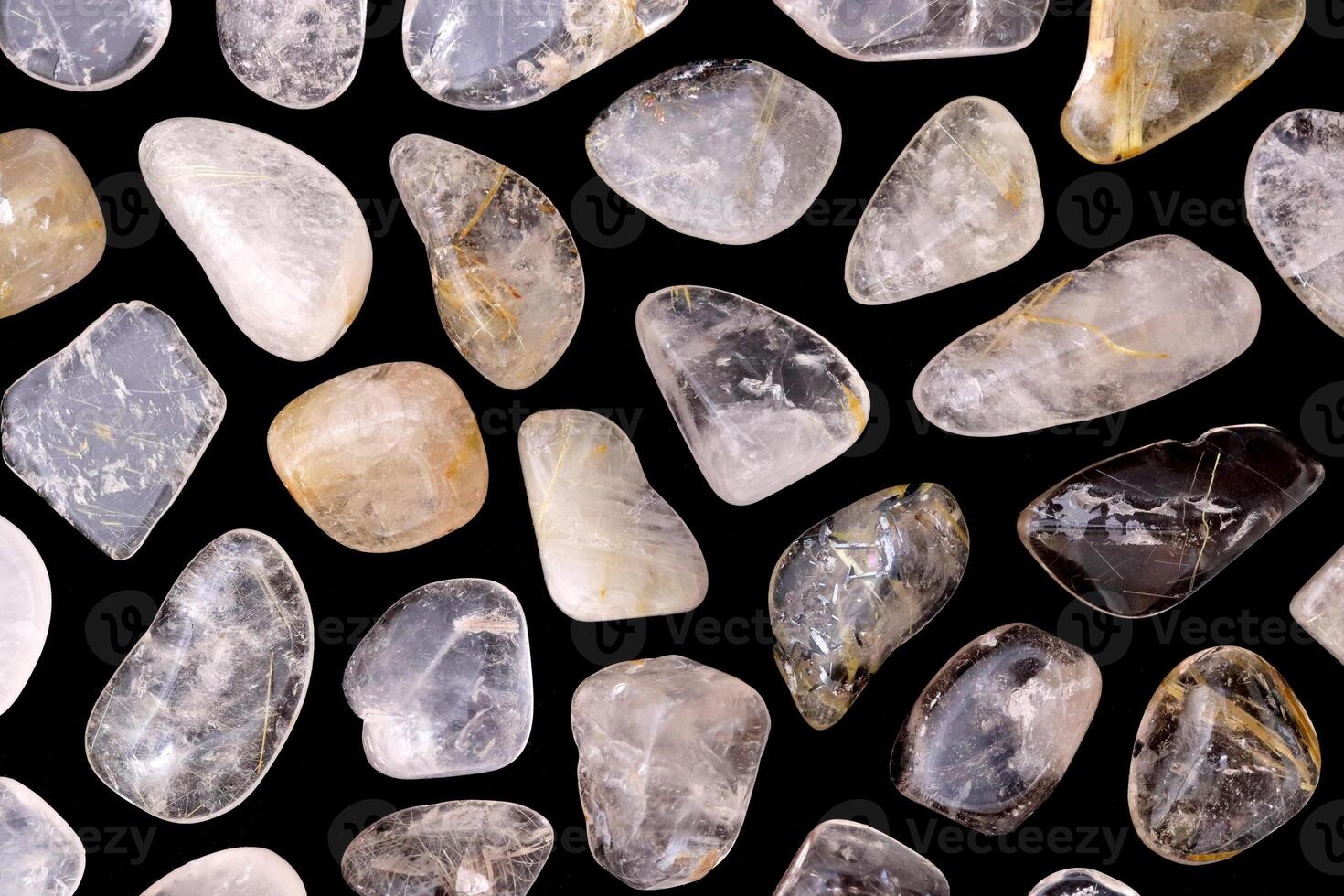 Rutilated quartz rare jewel stones texture on black background photo