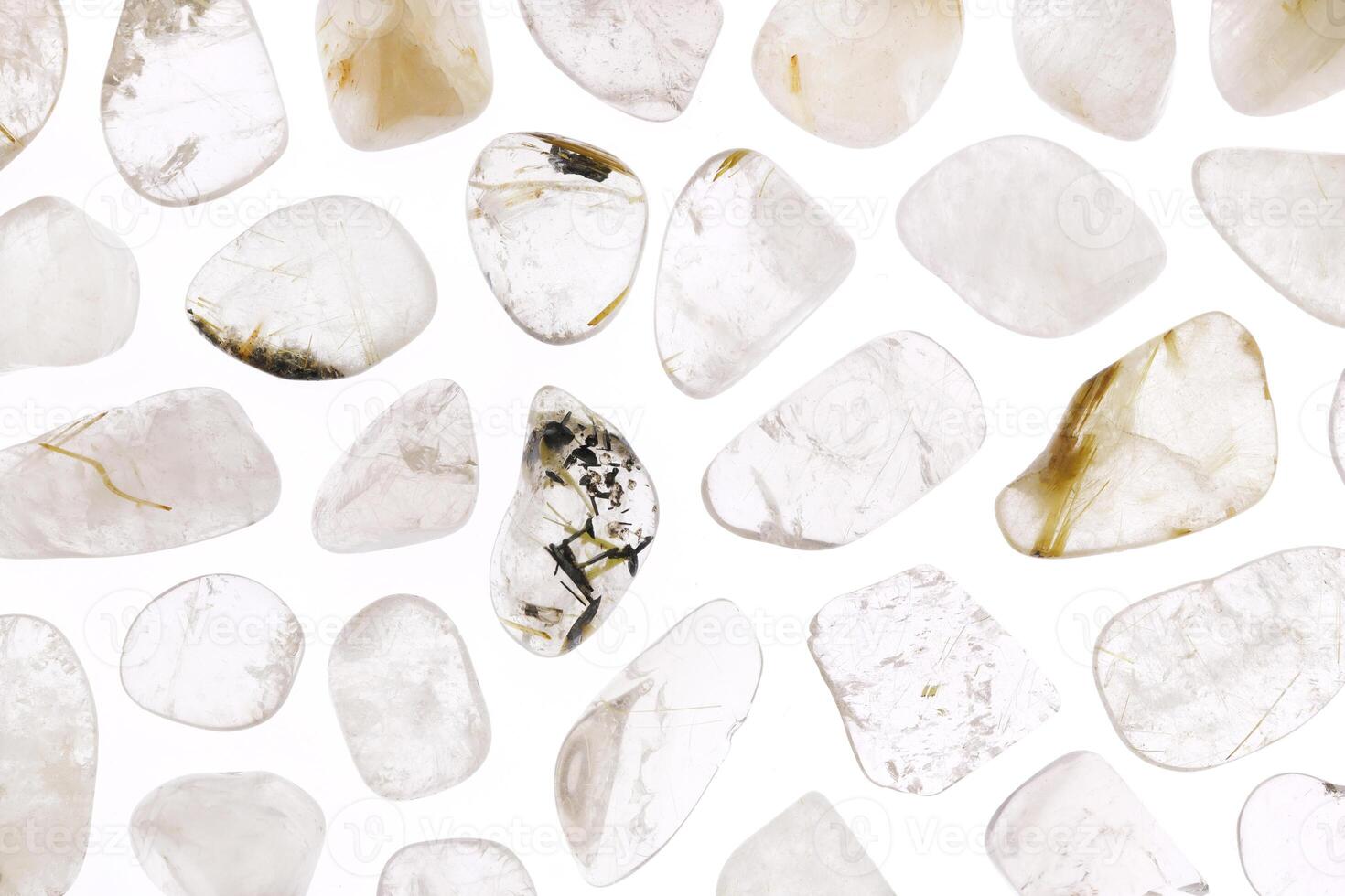 Rutilated quartz rare jewel stones texture on white light isolated background photo