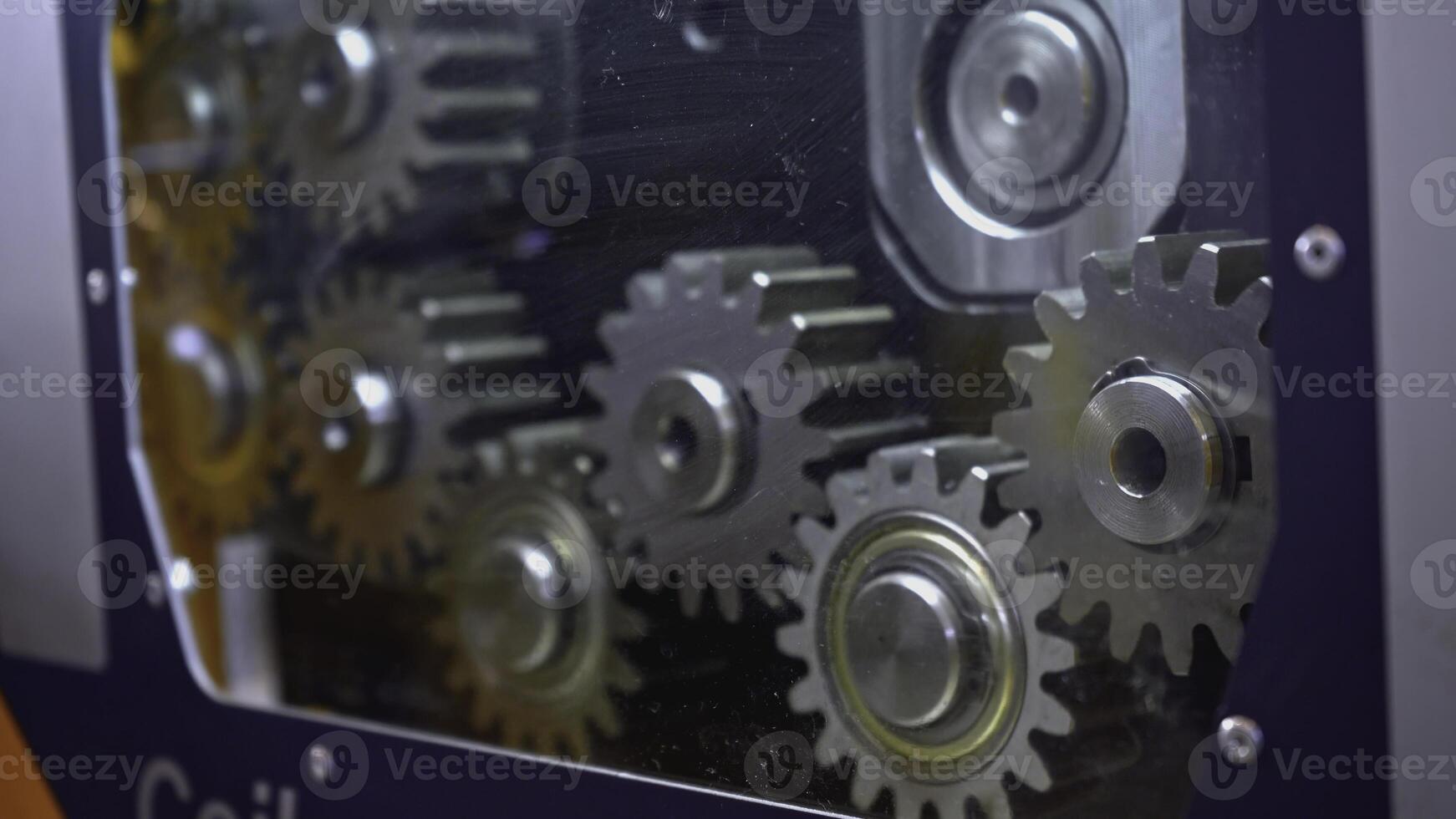 Mechanism with rotating gears. Media. Shiny metal gears rotate in moving mechanism. Industrial mechanism with rotating gears photo