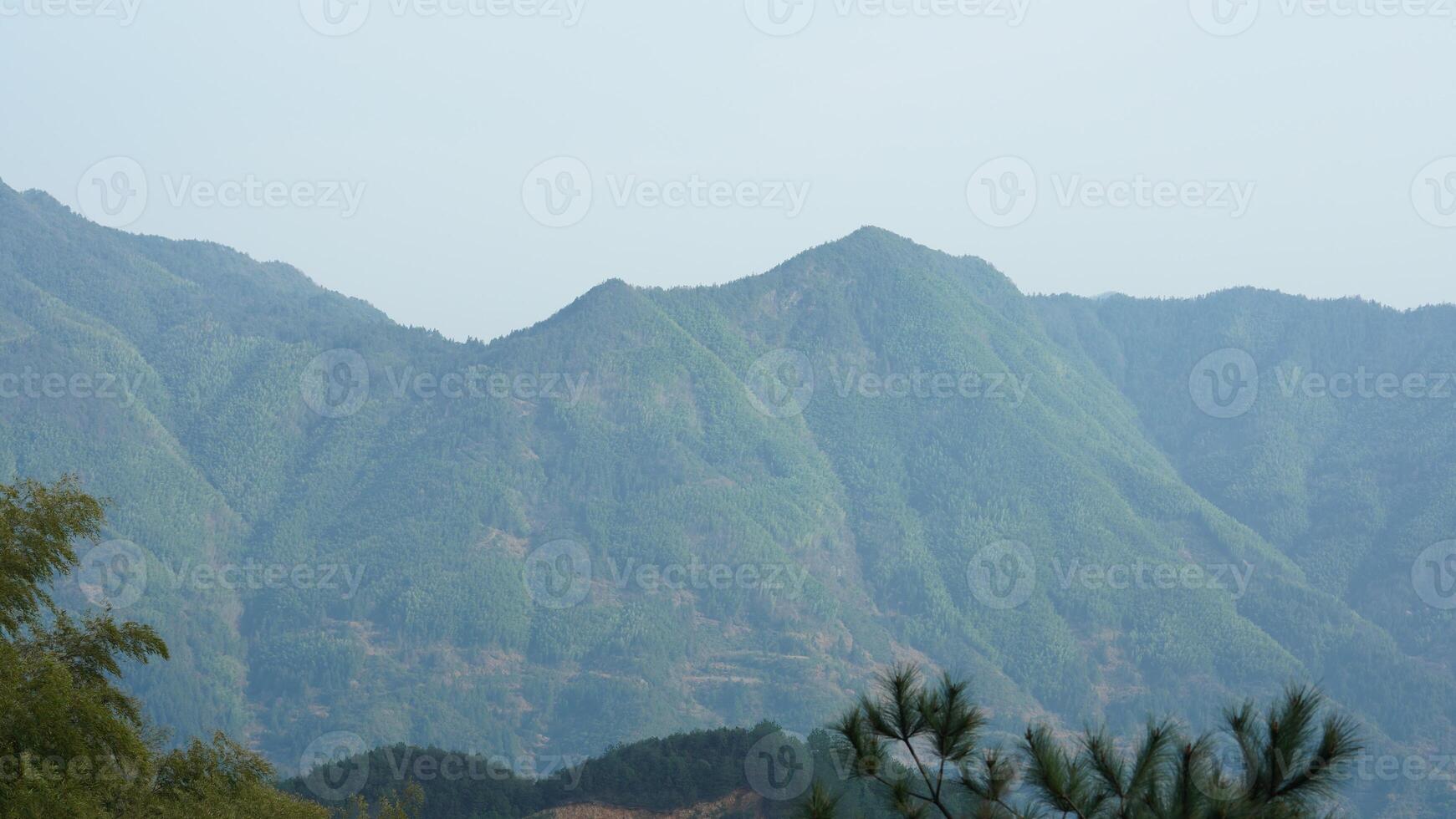 The beautiful mountains landscapes with the green forest and the erupted rock cliff as background in the countryside of the China photo