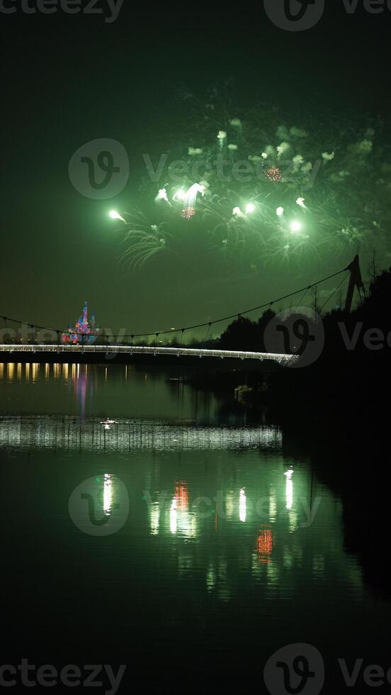 The colorful and beautiful fireworks show with the dark sky as background at night photo