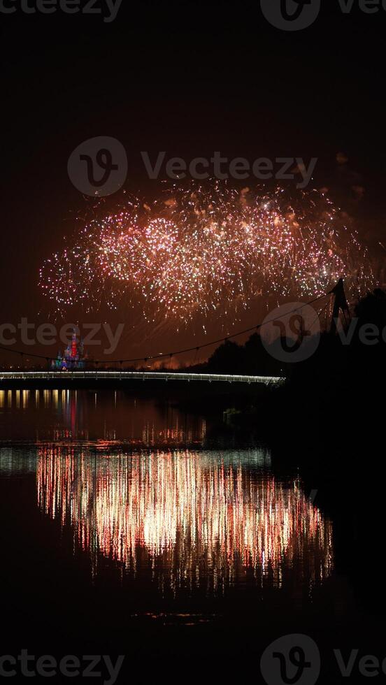The colorful and beautiful fireworks show with the dark sky as background at night photo