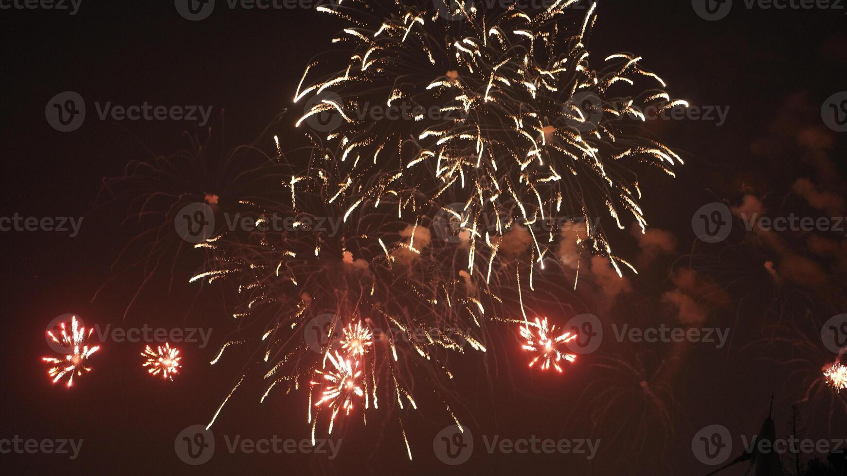 The colorful and beautiful fireworks show with the dark sky as background at night photo