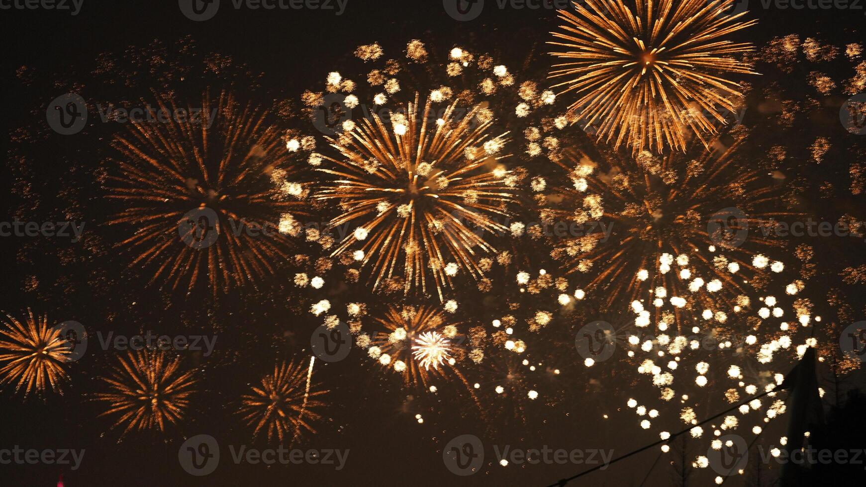 The colorful and beautiful fireworks show with the dark sky as background at night photo