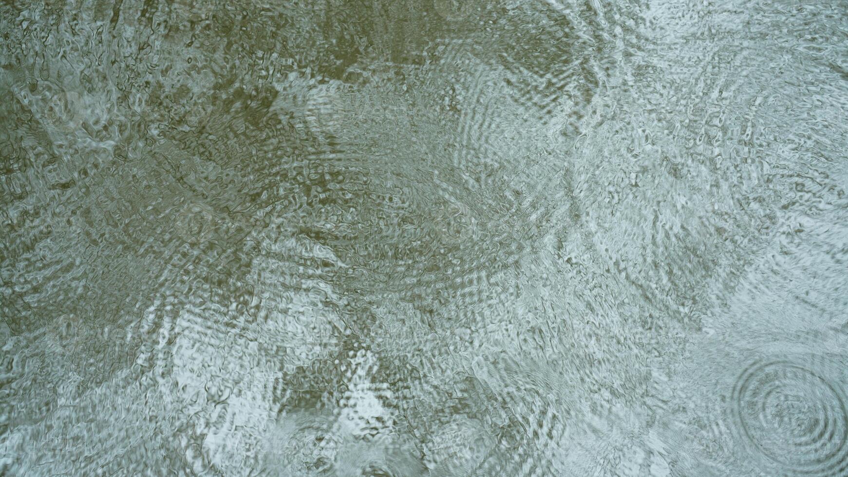 The pool water surface view with the ripples in the rainy day photo