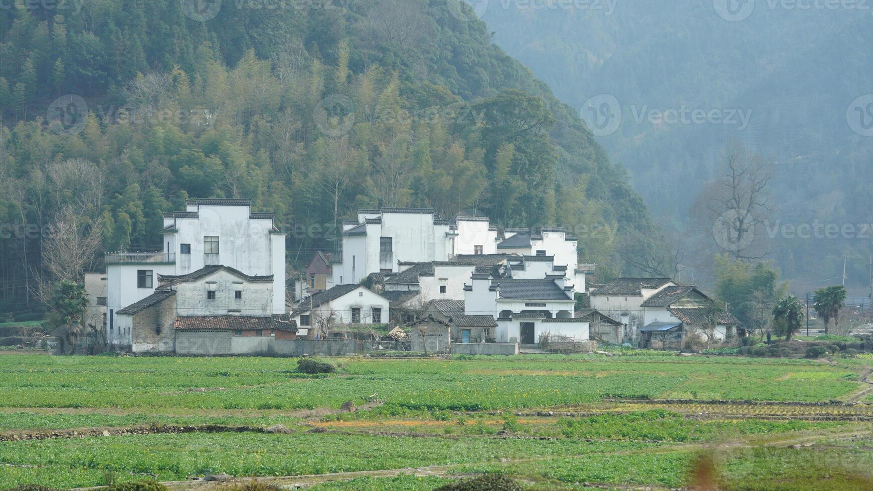 The beautiful mountains landscapes with the green forest and little village as background in the countryside of the China photo