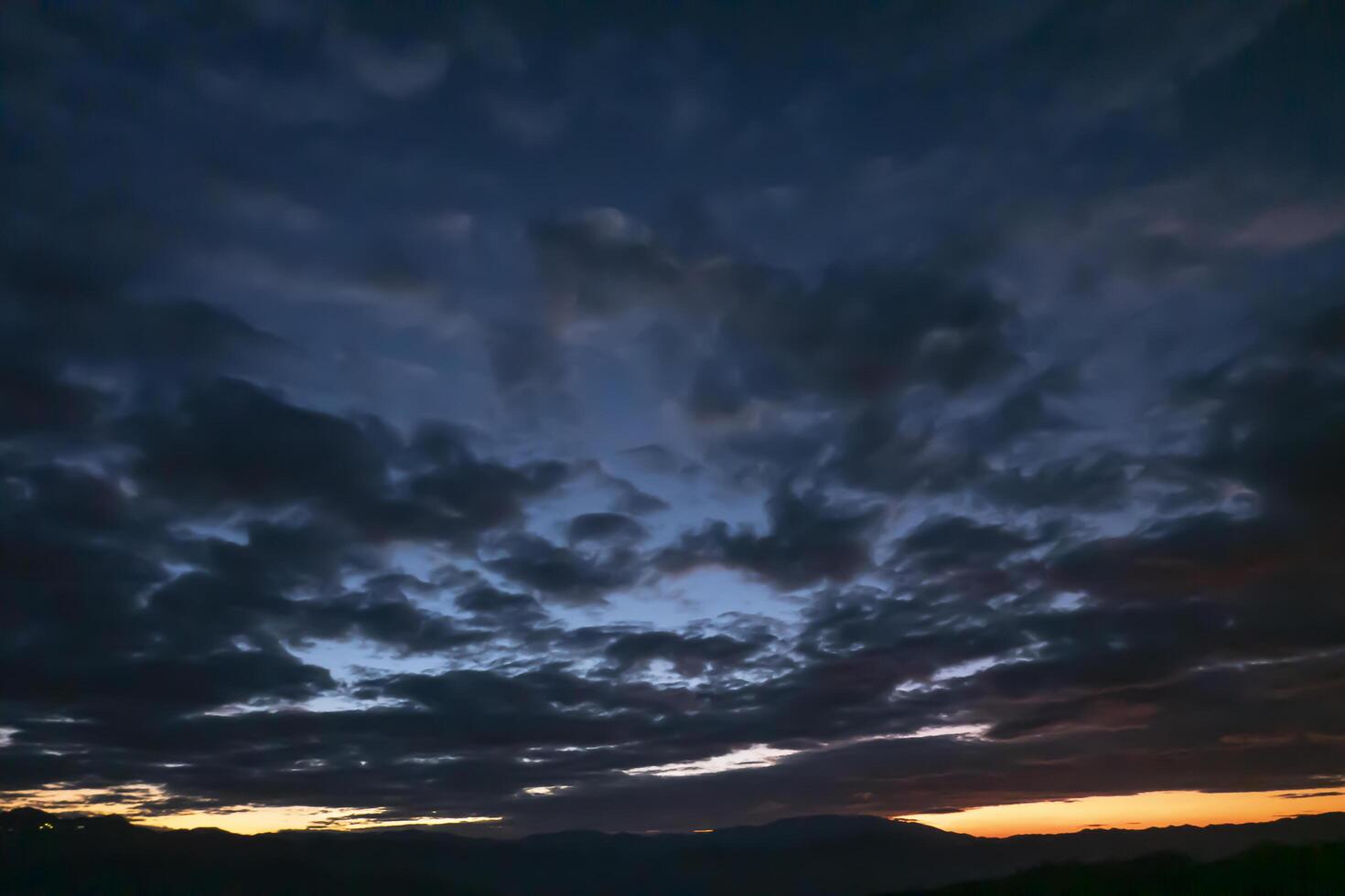 Mountain Sunset with Clouds, a Breathtaking Landscape Bathed in Evening Light and Mist, Capturing the Beauty of Nature's Colors and Tranquil Atmosphere photo