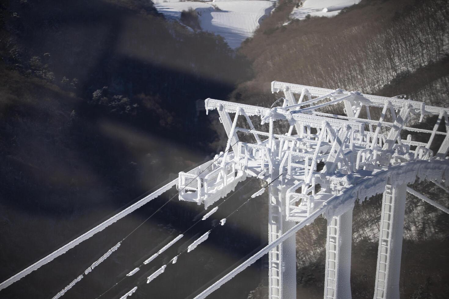 Cable car poles filled with ice and snow at Yongpyong Ski Resort, Mountain Winter South in Korea. photo