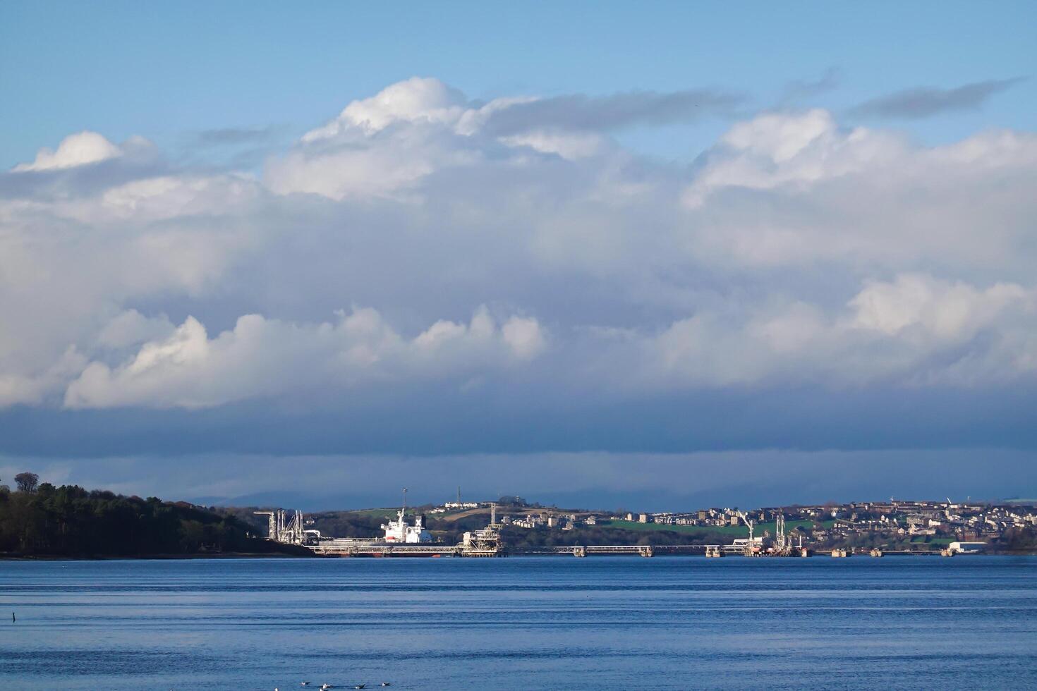 CRAMOND BEACH, A breathtaking view of Edinburgh city from the sea, with a picturesque landscape blending architecture, sky, and water photo