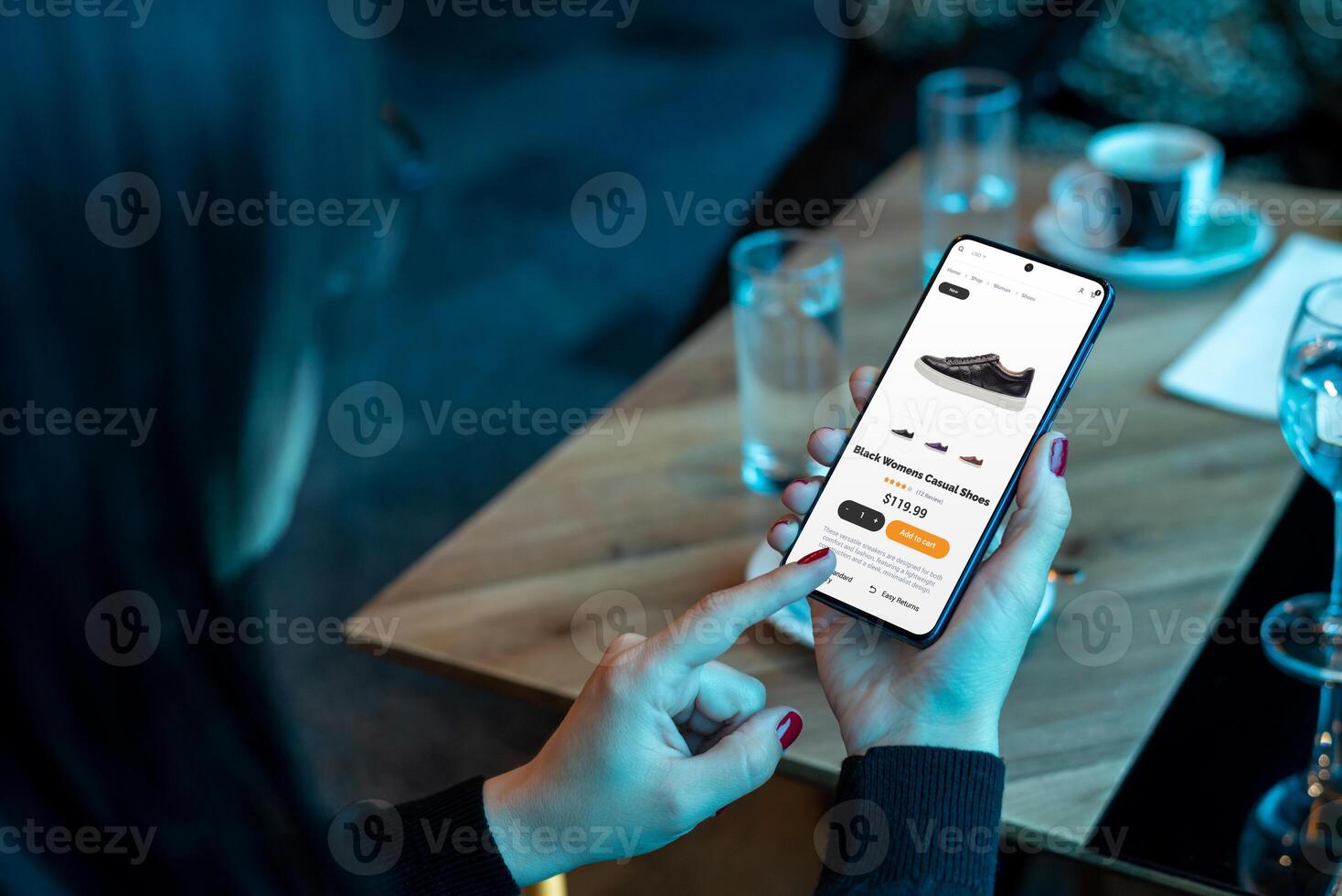 Woman uses mobile phone for buying shoes. Modern ecommerce app with user-friendly interface. Online shopping concept for convenience and efficiency photo