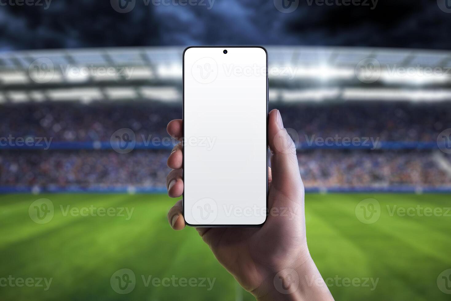 Mockup of a mobile phone in a hand at a football stadium, ideal for promoting sports apps and websites, capturing the stadium atmosphere photo