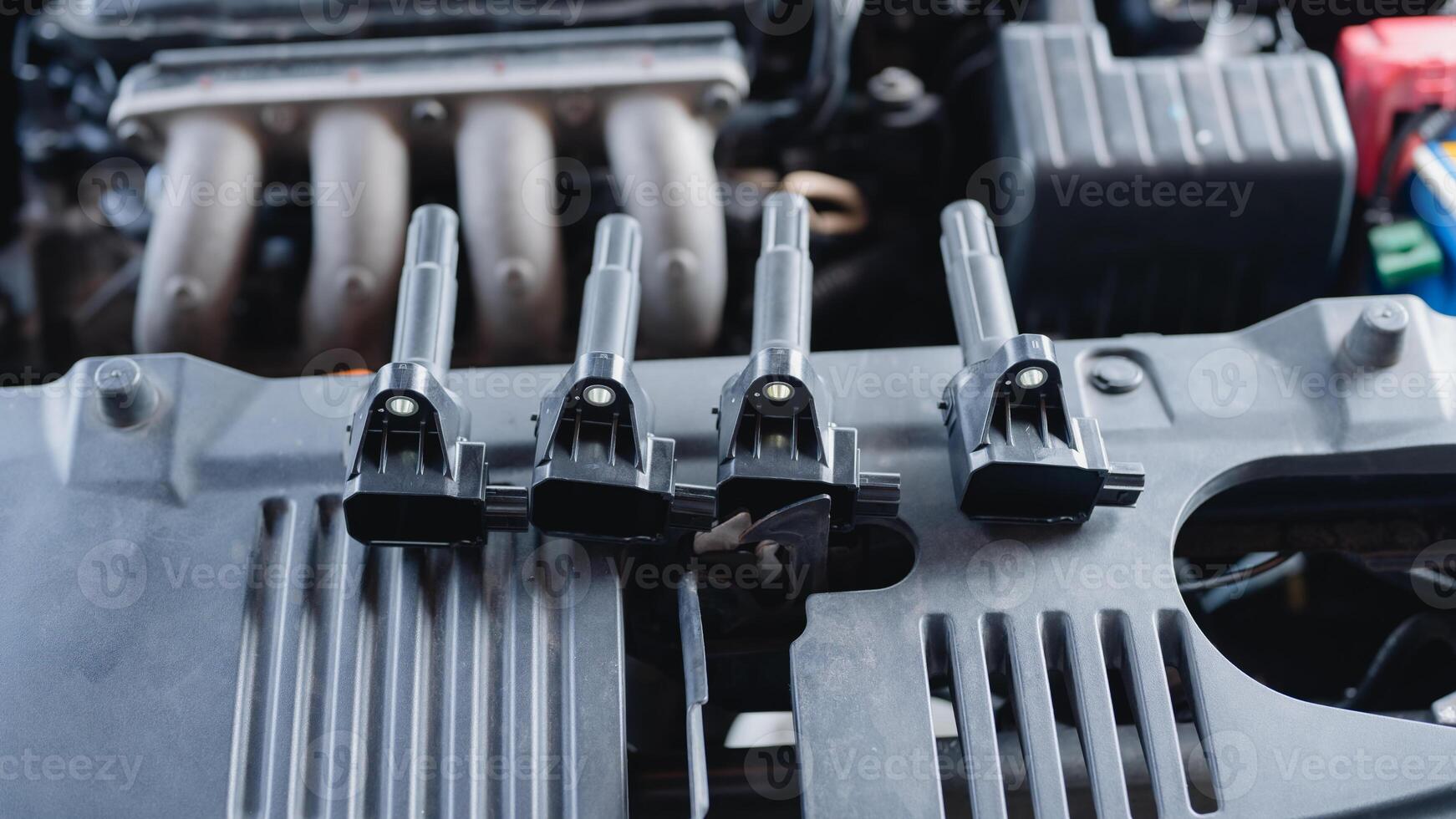 Automotive maintenance involves checking the ignition coil to keep the automobile running smoothly and prevent machine failures. photo