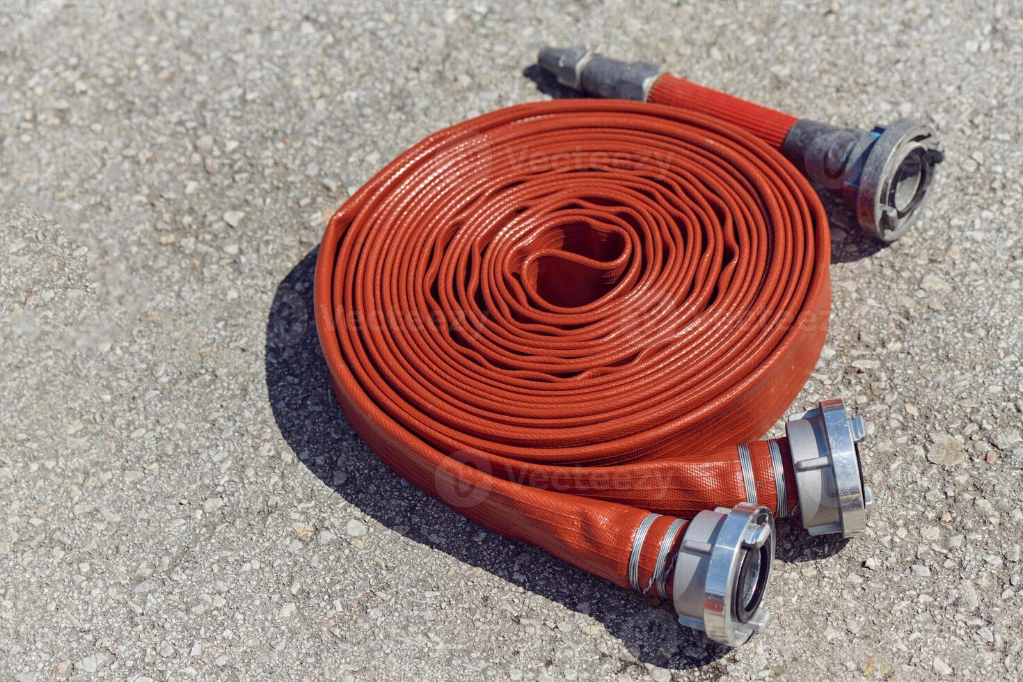 Coiled Fire Hose Ready for Action on the Ground photo