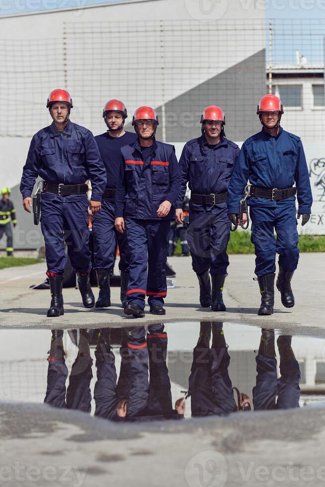 A team of confident and accomplished firefighters strides purposefully in their uniforms, exuding pride and satisfaction after successfully completing a challenging firefighting mission photo