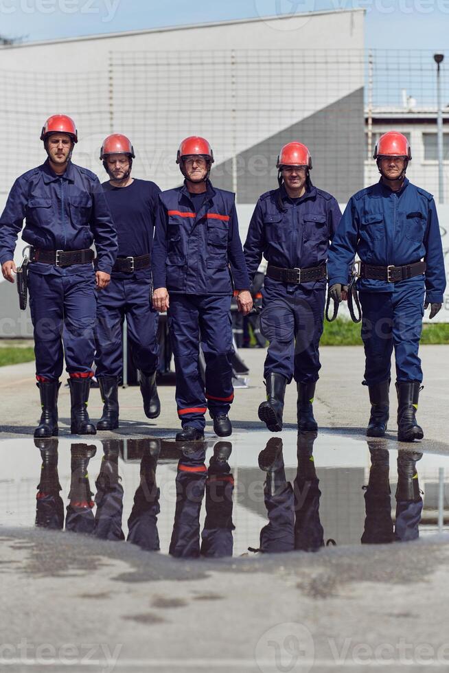 A team of confident and accomplished firefighters strides purposefully in their uniforms, exuding pride and satisfaction after successfully completing a challenging firefighting mission photo