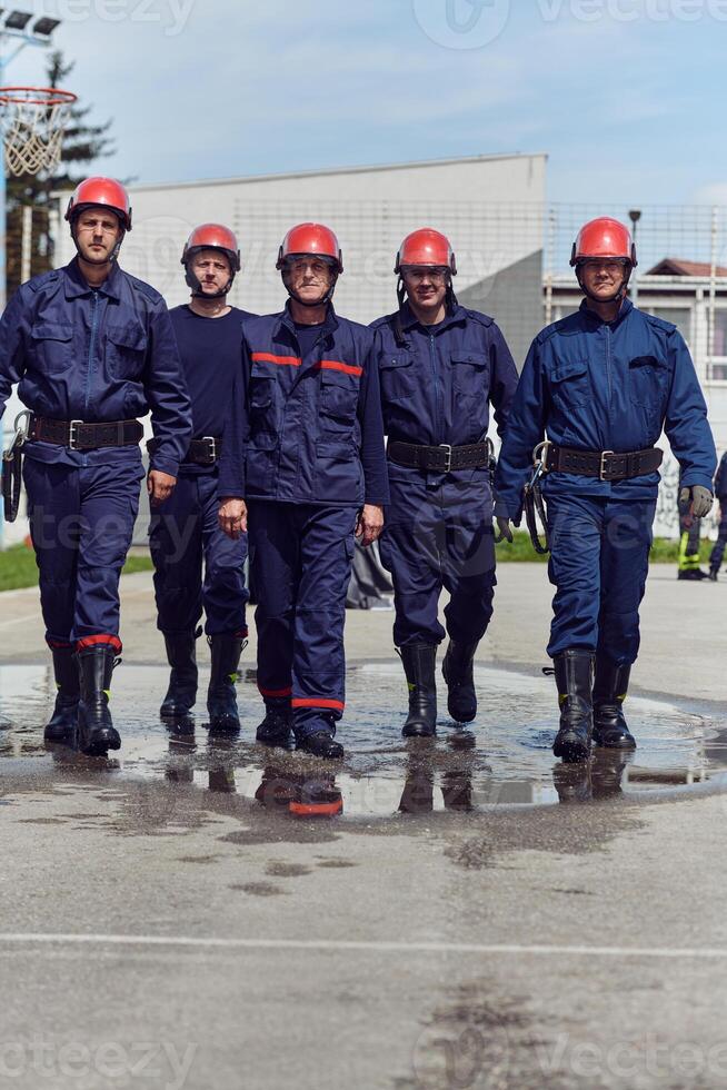 A team of confident and accomplished firefighters strides purposefully in their uniforms, exuding pride and satisfaction after successfully completing a challenging firefighting mission photo