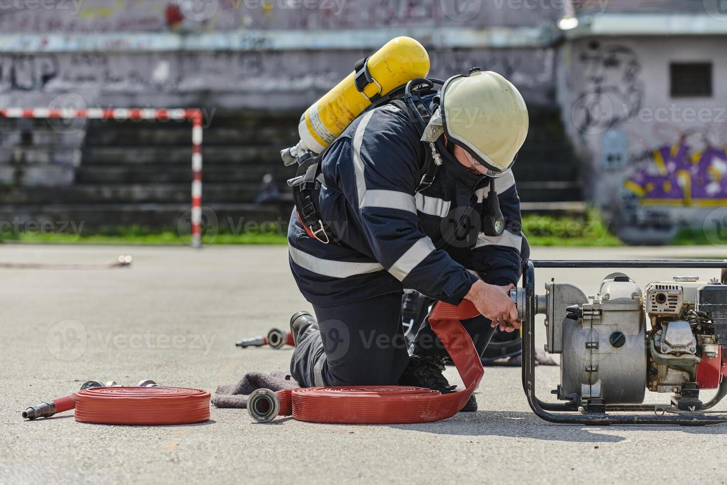A firefighter dons the essential components of their professional gear, embodying resilience, commitment, and readiness as they gear up for a hazardous firefighting mission, a testament to their photo