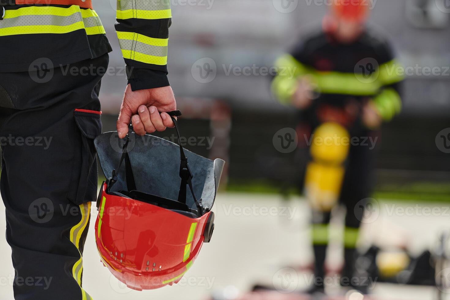 Close up of Firefighter's Hand Holding Fire Helmet photo