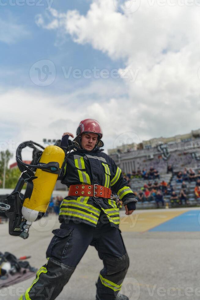 A firefighter dons the essential components of their professional gear, embodying resilience, commitment, and readiness as they gear up for a hazardous firefighting mission, a testament to their photo