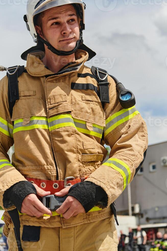 A firefighter dons the essential components of their professional gear, embodying resilience, commitment, and readiness as they gear up for a hazardous firefighting mission, a testament to their photo