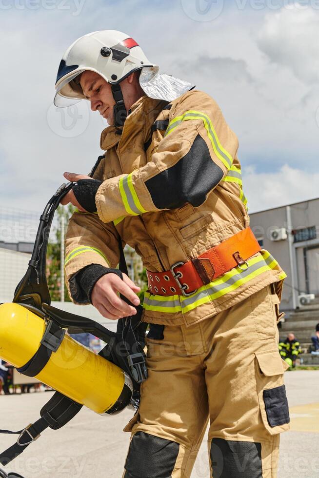 A firefighter dons the essential components of their professional gear, embodying resilience, commitment, and readiness as they gear up for a hazardous firefighting mission, a testament to their photo