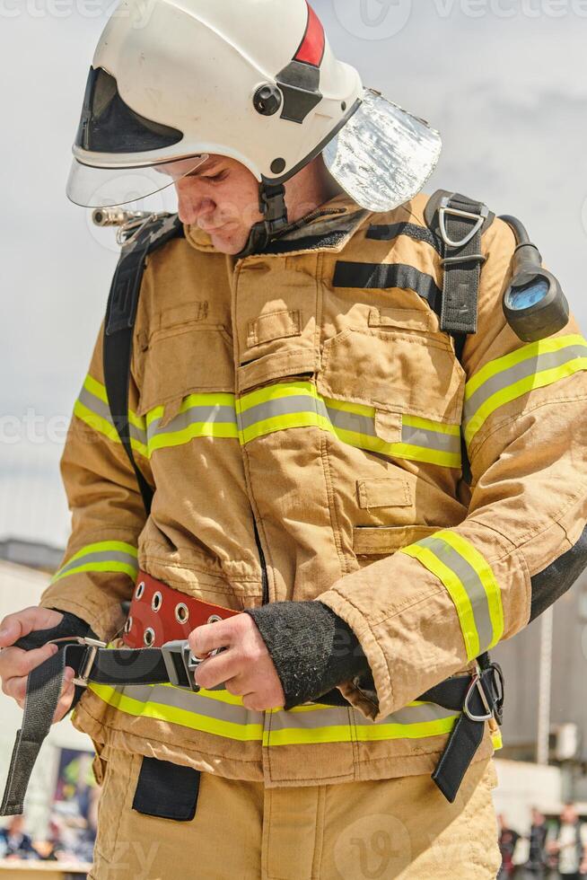 A firefighter dons the essential components of their professional gear, embodying resilience, commitment, and readiness as they gear up for a hazardous firefighting mission, a testament to their photo