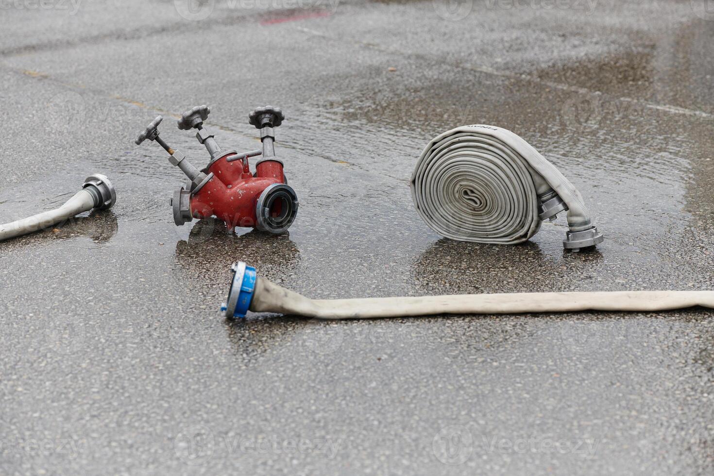Coiled Fire Hose Ready for Action on the Ground photo