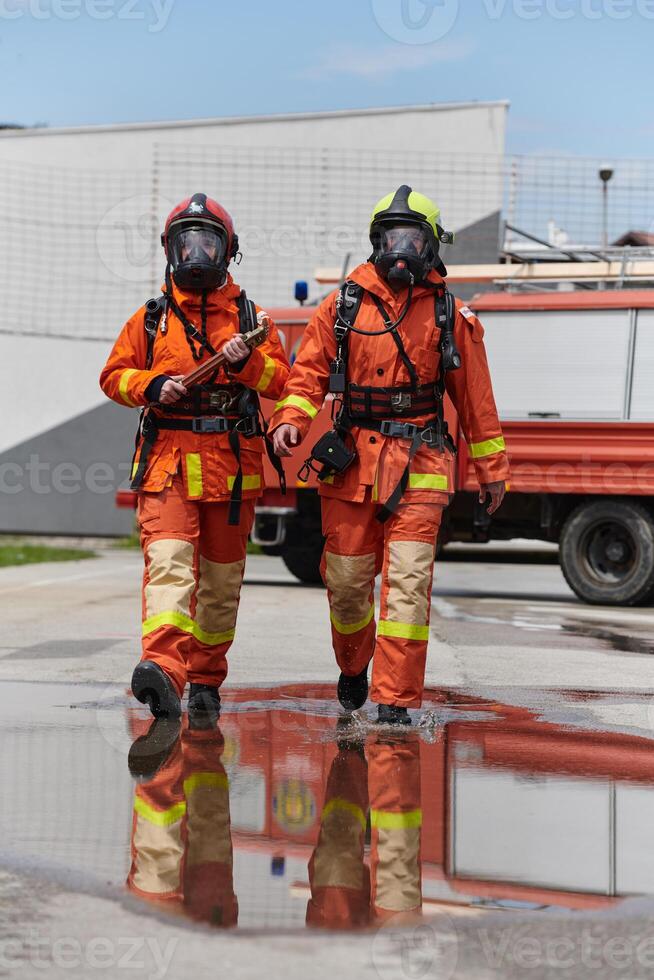 A team of confident and accomplished firefighters strides purposefully in their uniforms, exuding pride and satisfaction after successfully completing a challenging firefighting mission photo
