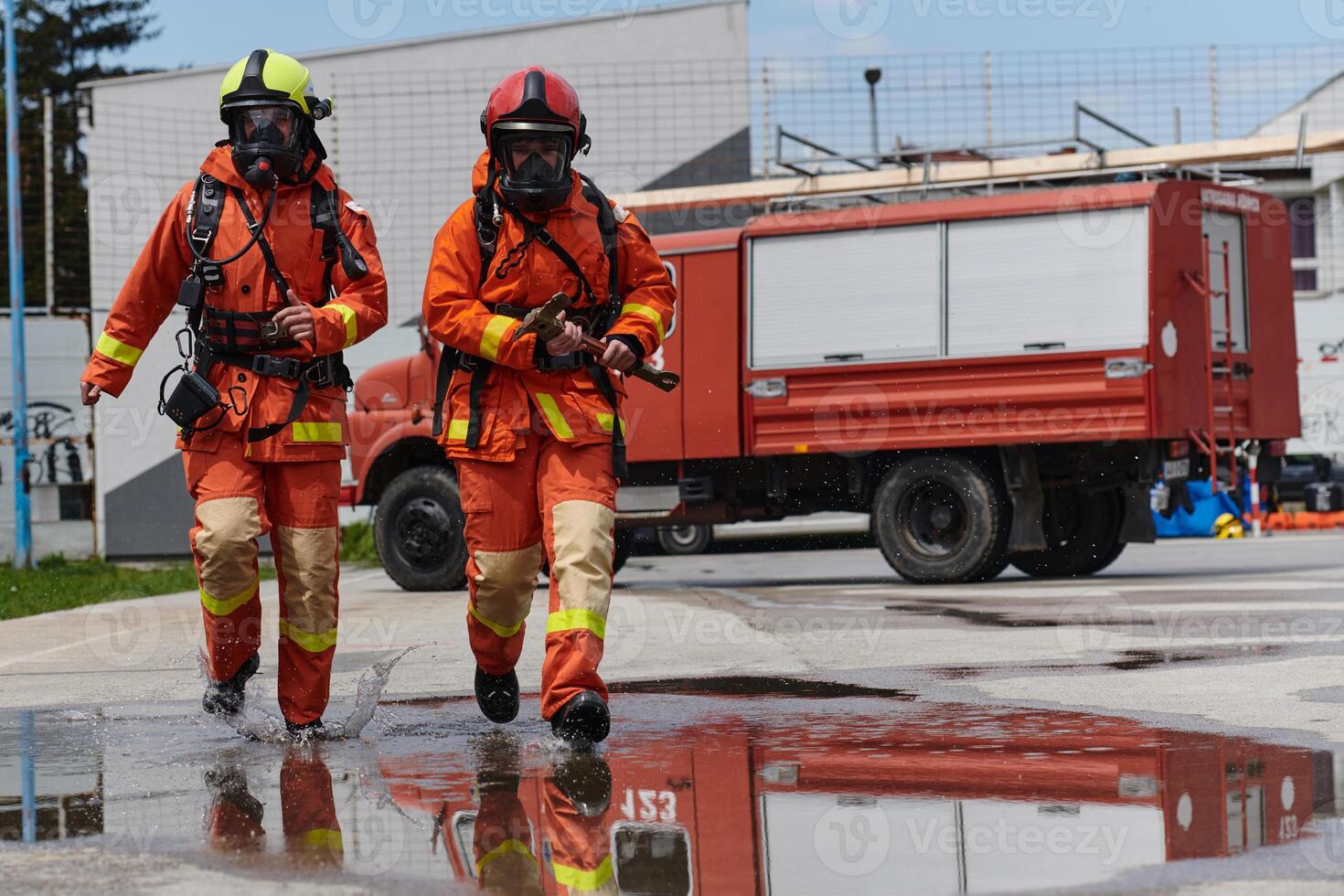 Firefighter Team Training with Various Tools in Professional Gear photo