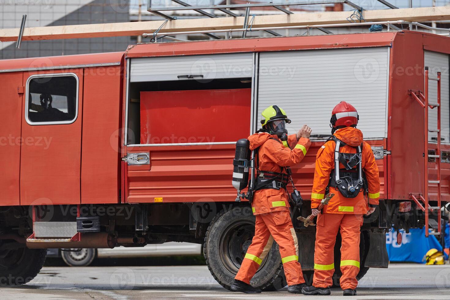 Firefighter Team Training with Various Tools in Professional Gear photo