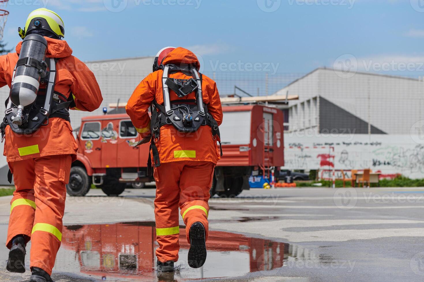 Firefighter Team Training with Various Tools in Professional Gear photo