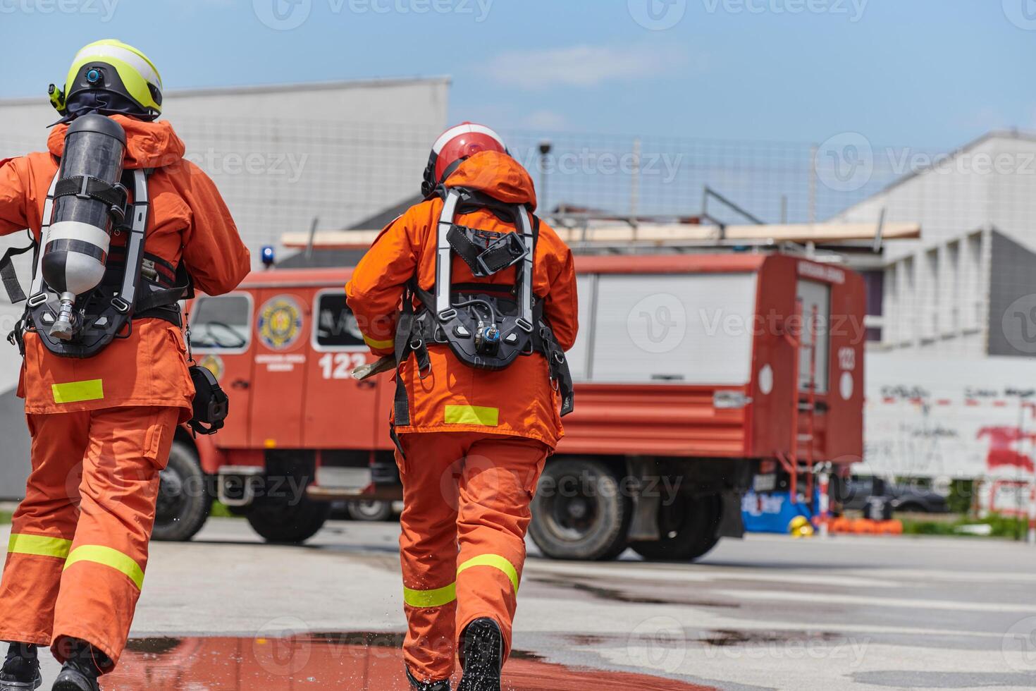 Firefighter Team Training with Various Tools in Professional Gear photo