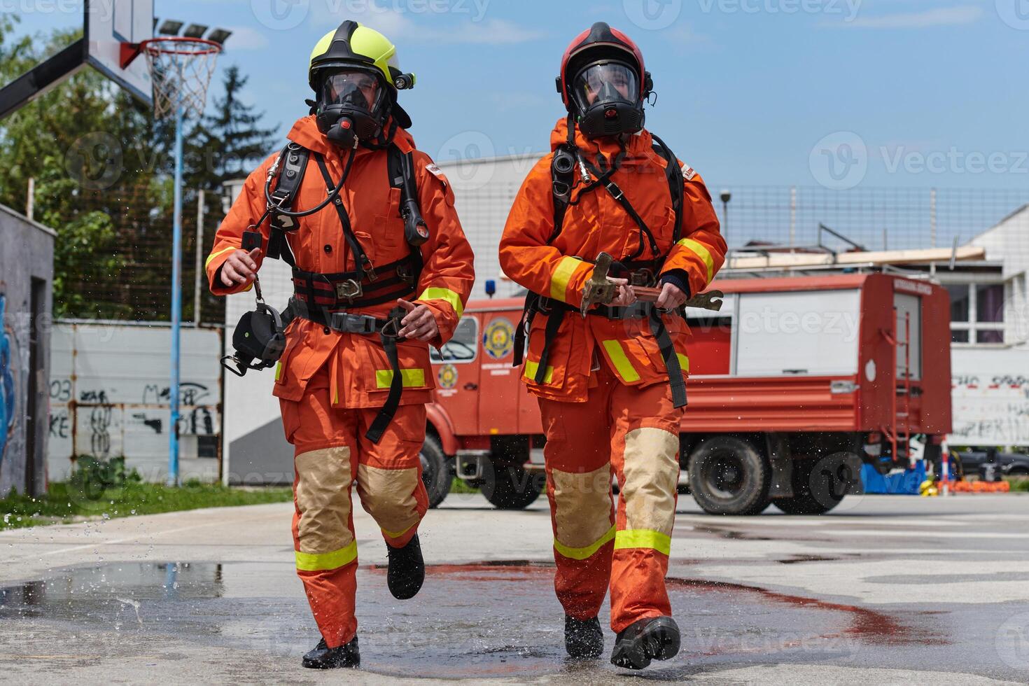 Firefighter Team Training with Various Tools in Professional Gear photo