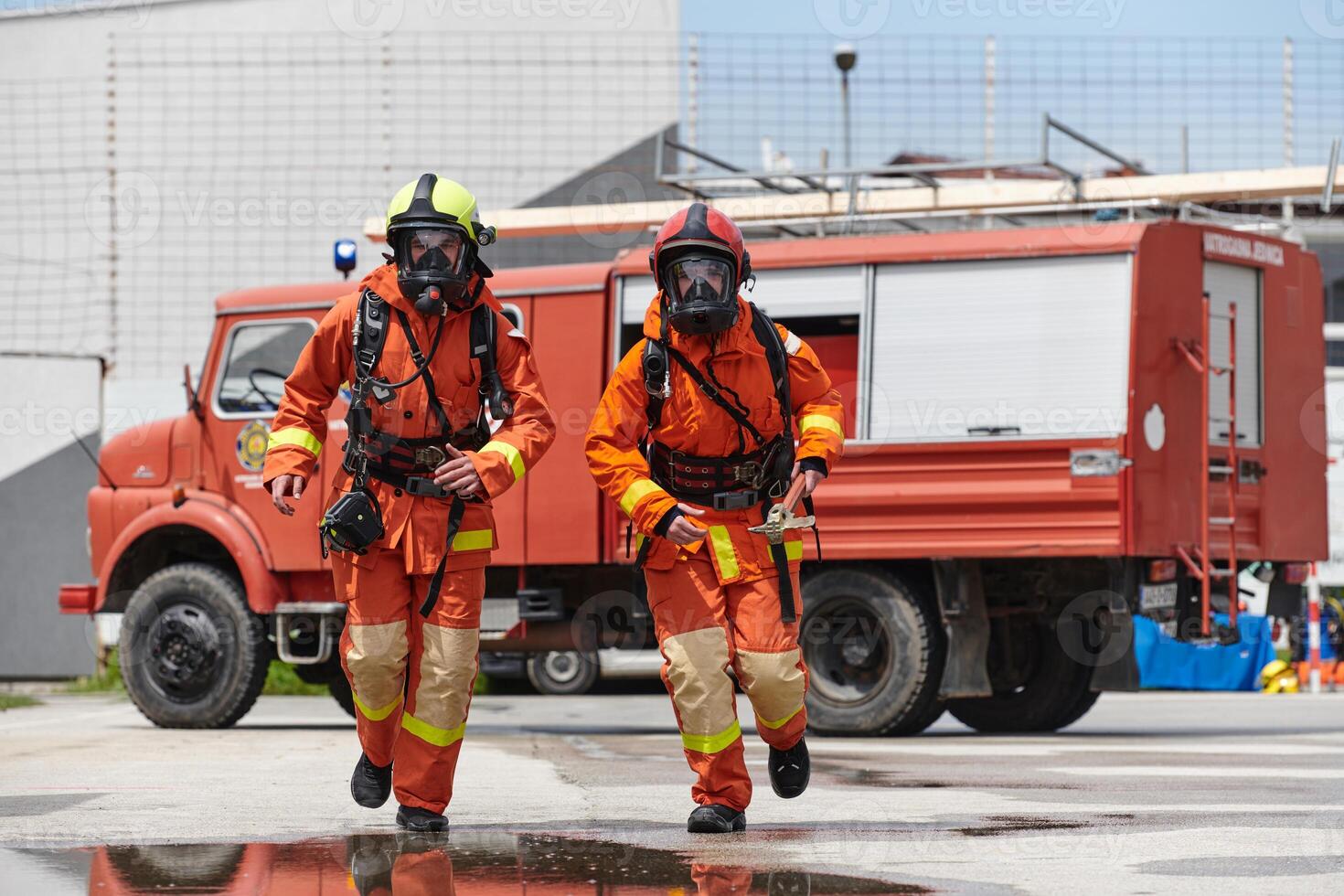 A team of confident and accomplished firefighters strides purposefully in their uniforms, exuding pride and satisfaction after successfully completing a challenging firefighting mission photo