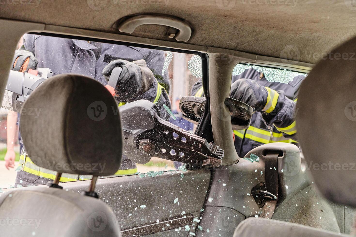 A dedicated team of professional firefighters employs specialized tools to cut and break through vehicle wreckage, showcasing their skilled collaboration and swift response in rescuing individuals photo