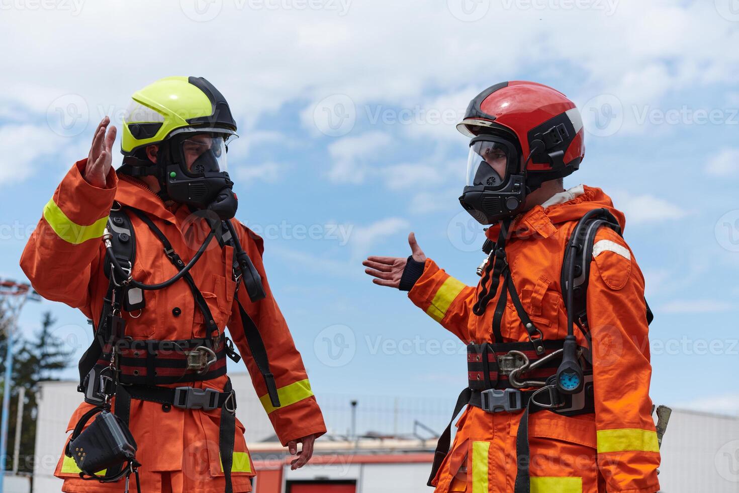 A unified team of firefighters, adorned in their uniforms, engages in a heartfelt celebration marked by triumphant salutes and cheers, embodying the joy and gratitude following the successful photo