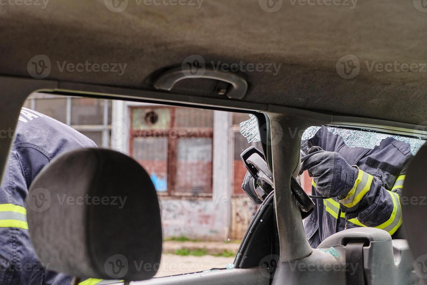 A dedicated team of professional firefighters employs specialized tools to cut and break through vehicle wreckage, showcasing their skilled collaboration and swift response in rescuing individuals photo