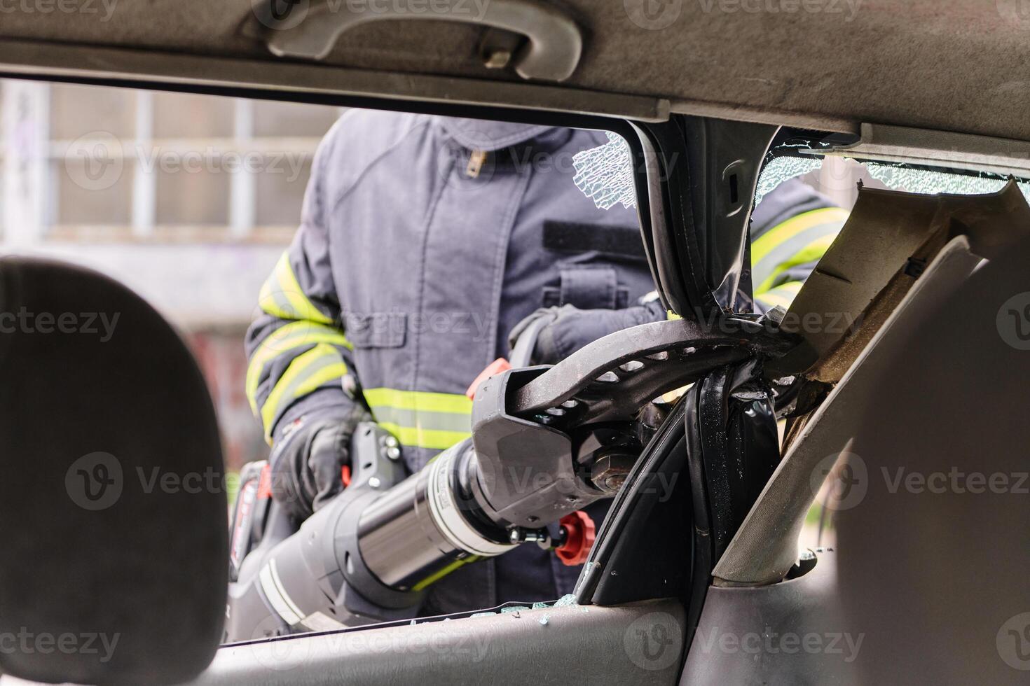 A dedicated team of professional firefighters employs specialized tools to cut and break through vehicle wreckage, showcasing their skilled collaboration and swift response in rescuing individuals photo