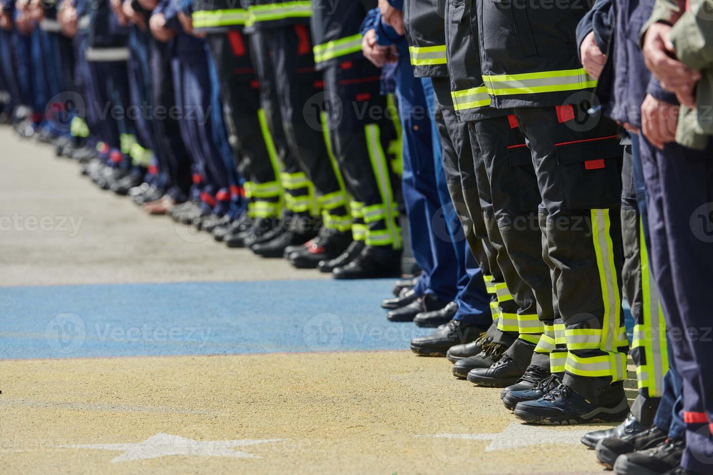 A group of firefighters lined up, saluting the flag, applauding in solidarity, and gearing up for intensive training sessions, showcasing their unwavering commitment to service and teamwork. photo