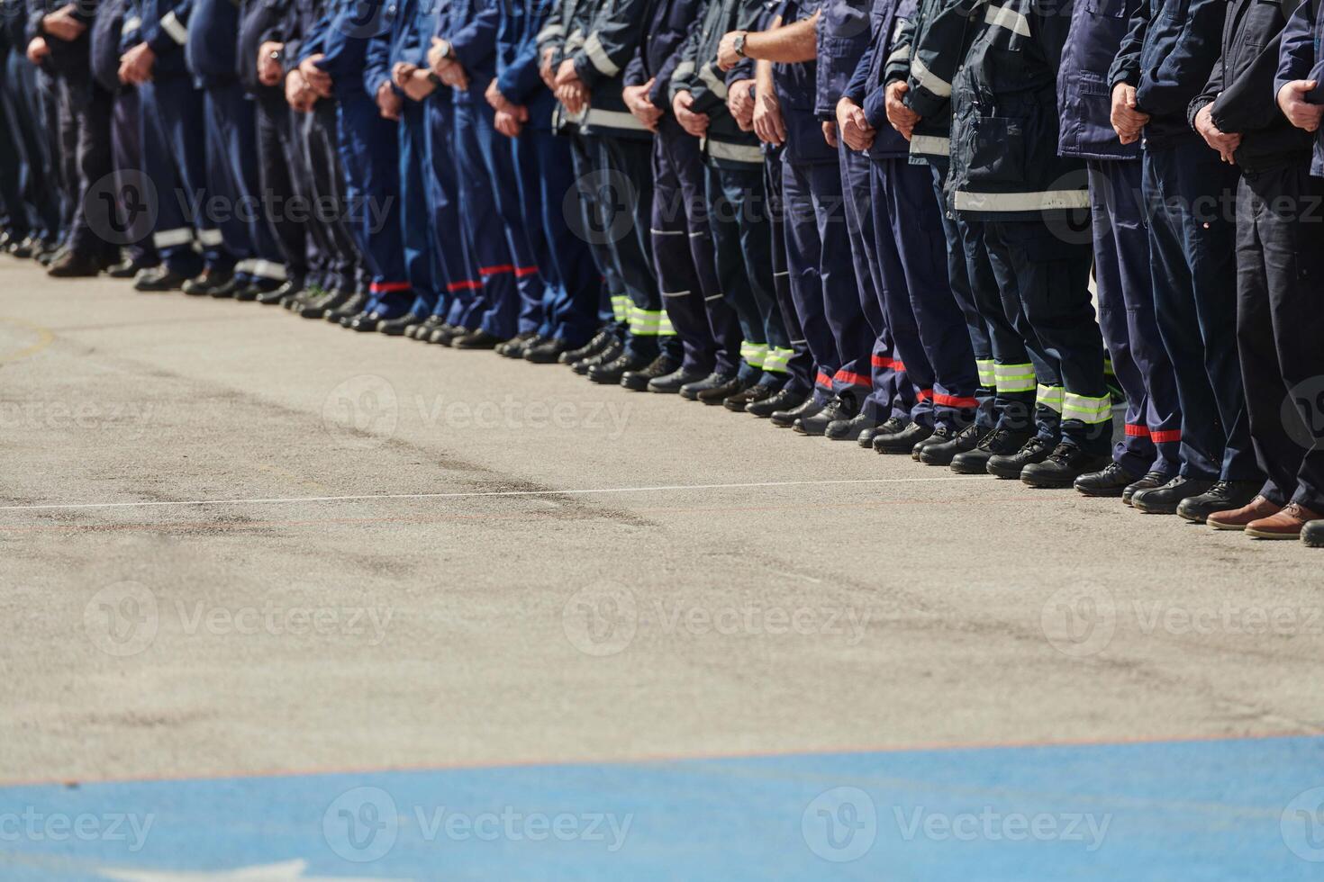 A group of firefighters lined up, saluting the flag, applauding in solidarity, and gearing up for intensive training sessions, showcasing their unwavering commitment to service and teamwork. photo