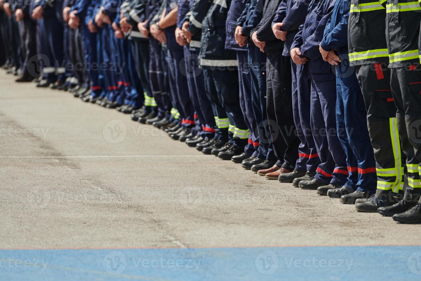 A group of firefighters lined up, saluting the flag, applauding in solidarity, and gearing up for intensive training sessions, showcasing their unwavering commitment to service and teamwork. photo